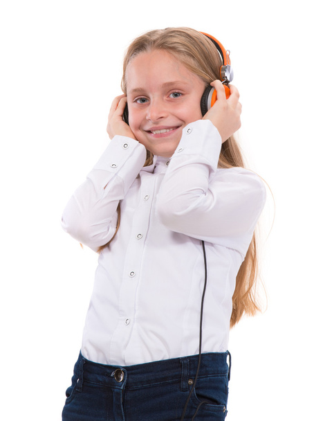 Little girl in headphones listening to music - Фото, зображення