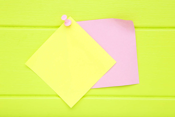 Paper sticky notes on green wooden table - Photo, image