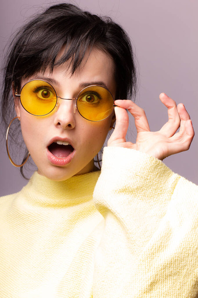 beautiful girl in yellow glasses and a yellow sweater - Photo, image