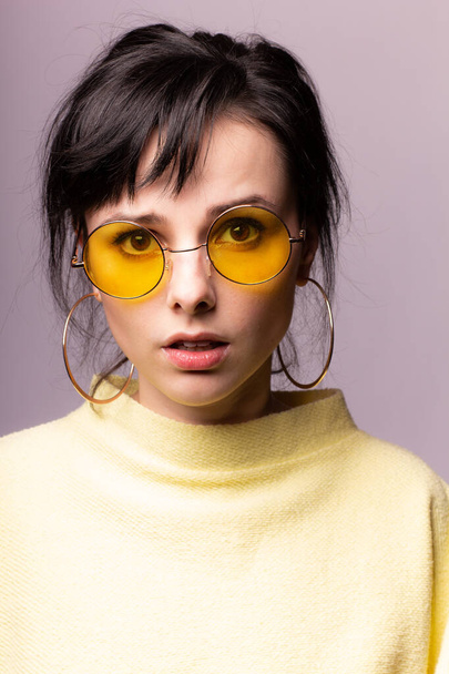 beautiful girl in yellow glasses and a yellow sweater - Фото, изображение