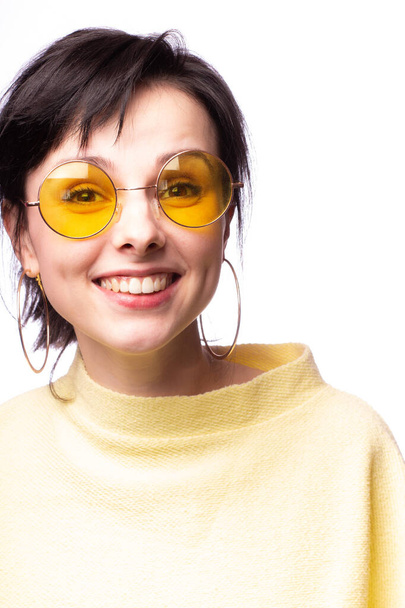 beautiful girl in yellow glasses and a yellow sweater - Fotoğraf, Görsel
