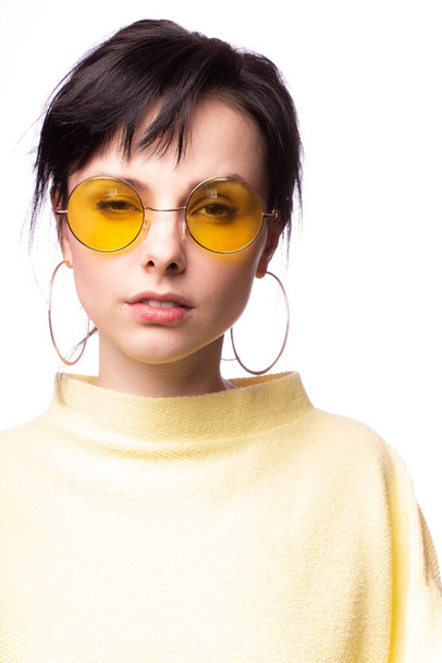 beautiful girl in yellow glasses and a yellow sweater - Foto, imagen