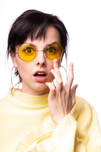 beautiful girl in yellow glasses and a yellow sweater - Fotó, kép