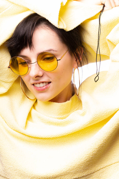 beautiful girl in yellow glasses and a yellow sweater - Фото, зображення