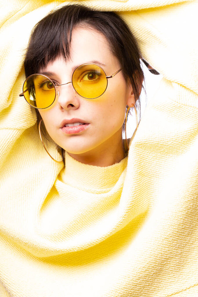 beautiful girl in yellow glasses and a yellow sweater - Foto, immagini