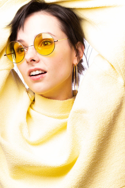 beautiful girl in yellow glasses and a yellow sweater - Photo, Image