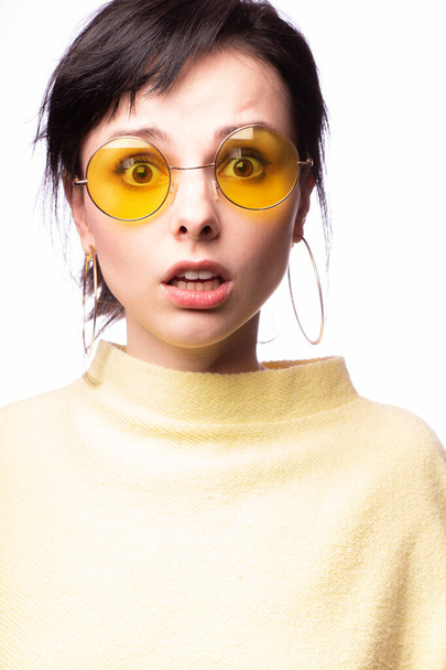 beautiful girl in yellow glasses and a yellow sweater - 写真・画像