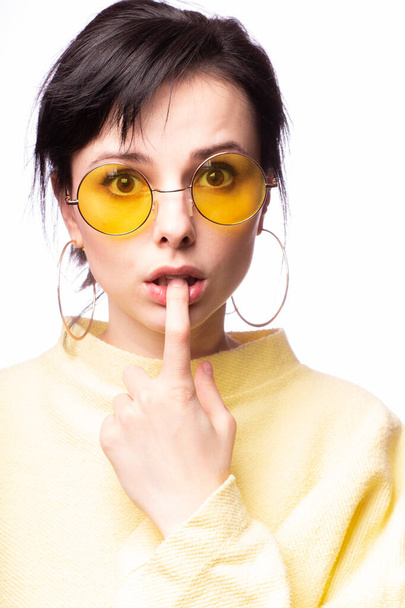 beautiful girl in yellow glasses and a yellow sweater - Фото, изображение