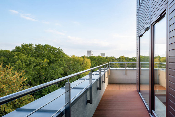 Elegant building with stylish balcony and amazing view on green trees - Valokuva, kuva