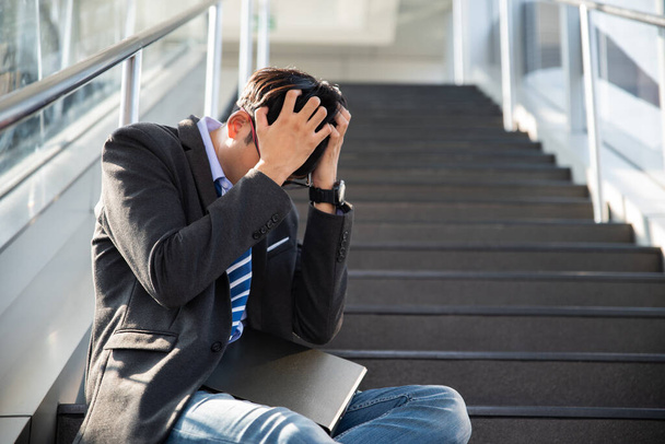 Businessman lost in depression crying sitting on ground street stairs suffering emotional pain sadness. Unemployed jobless people crisis who stress and lose job. Stressed jobless concept. - Photo, Image