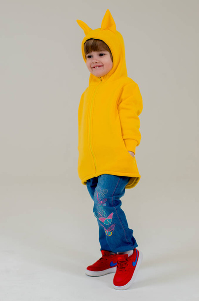 Model baby girl in the Studio. Industry children's clothing. Little girl in a funny costume - Fotografie, Obrázek