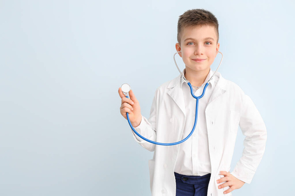 Cute little doctor on color background - Photo, image