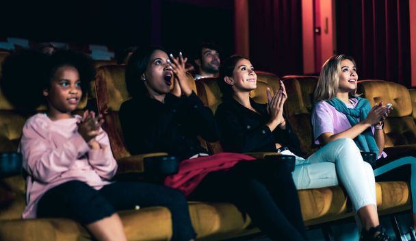 People audience watching movie in the movie theater cinema. Group recreation activity and entertainment concept. - 写真・画像