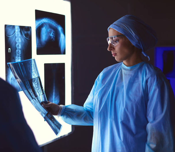 Image of attractive woman doctor looking at x-ray results - Foto, Bild