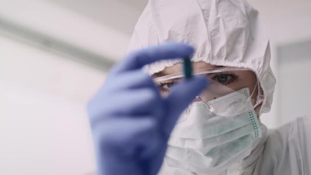 Handheld view of technician holding medicine. Shot with RED helium camera in 8K - Materiaali, video