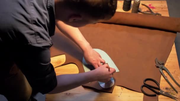 Man draws a shoe with pencil on a table  - Footage, Video