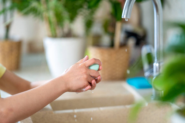 child washes his hands with soap at home. The concept of protection from viruses. hand hygiene. Fight against microbes, viruses, bacteria, covid-19. Stay home. Quarantine. World pandemic. - Photo, Image