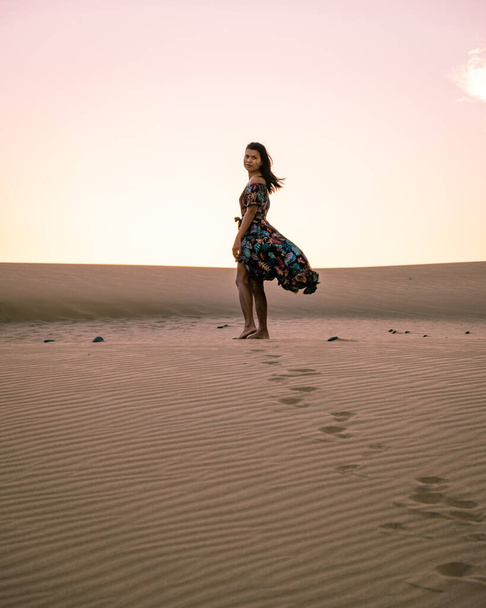 woman walking at the beach of Maspalomas Gran Canaria Spain, girl at the sand dunes desert of Maspalomas - Photo, Image