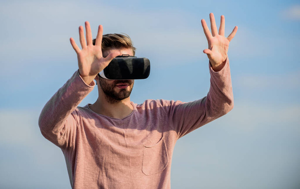 macho man wear wireless VR glasses. Enjoying new experience. Digital future and innovation. guy virtual reality goggles. sexy man sky background vr glasses. male reality. looking so modern - Zdjęcie, obraz