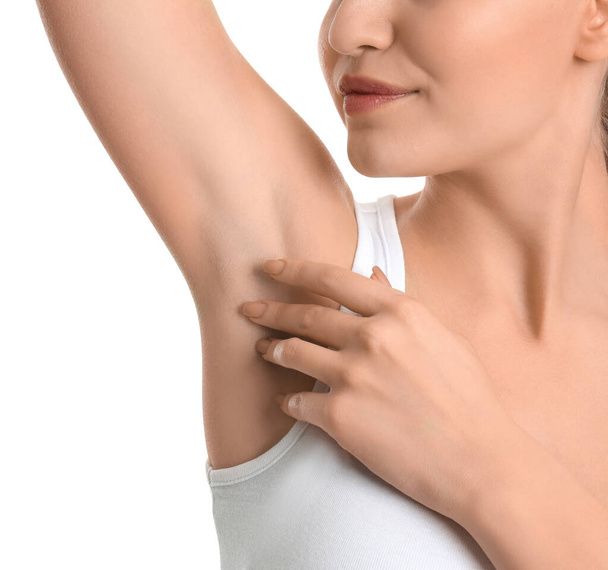 Young woman showing armpit with smooth clean skin on white background, closeup - Valokuva, kuva