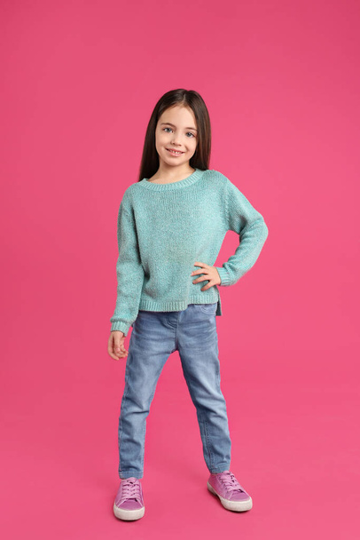 Cute little girl posing on pink background - Photo, image