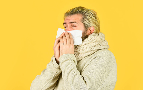 sick and tired. Home treatment. brutal man beard has runny nose. flu and virus infection symptoms. coronavirus from china. immunity against epidemic. hipster blow out nose in paper. Allergy concept - Foto, Bild