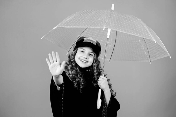 Trendy beauty. rain protection. Rainbow. happy little girl with transparent umbrella. autumn fashion. little girl in french beret and coat. cheerful hipster child in positive mood - Foto, Bild