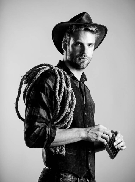have a drink. wild west rodeo. man in hat drink whiskey. man checkered shirt on ranch. cowboy with lasso rope. Western. Vintage style man. Wild West retro cowboy. western cowboy portrait - Fotografie, Obrázek
