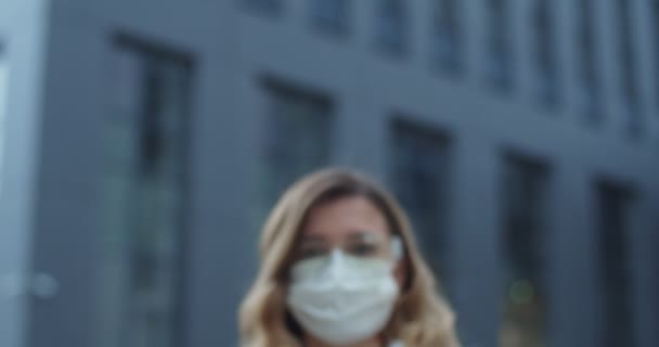 Stay at home, quarantine. Portrait of woman wearing mask and protective glasses looking to camera outdoor. Health and safety, N1H1 coronavirus, virus protection care and medical concept. - Video