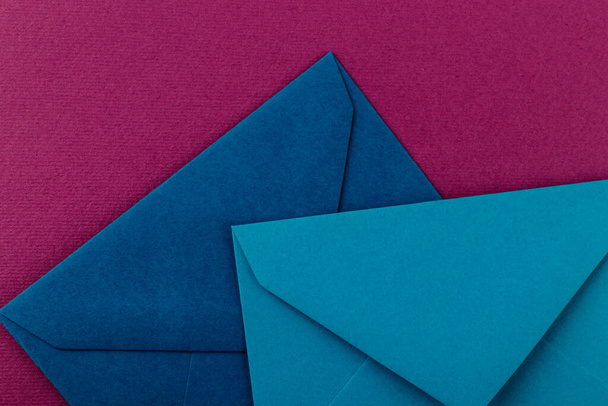 Colorful envelopes on a purple background. Mail envelopes on the table. - Фото, зображення