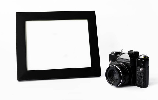 camera and photo frame on a white background, close up - Photo, Image