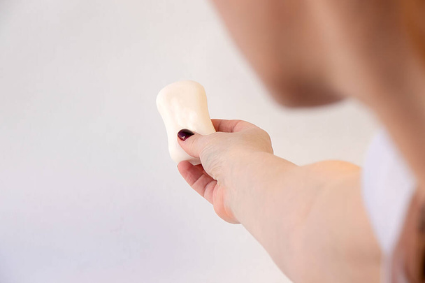 Girl extends her hand in which soap is located - 写真・画像