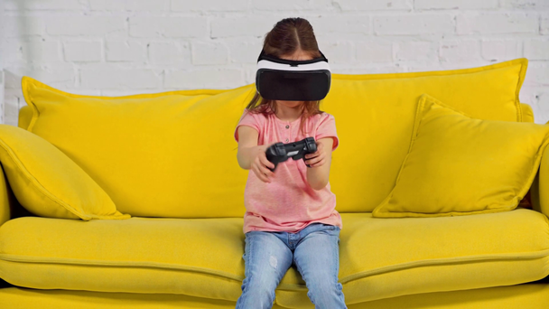 KYIV, UKRAINE - MARCH 11, 2020: kid in virtual reality headset playing video game  - Кадри, відео