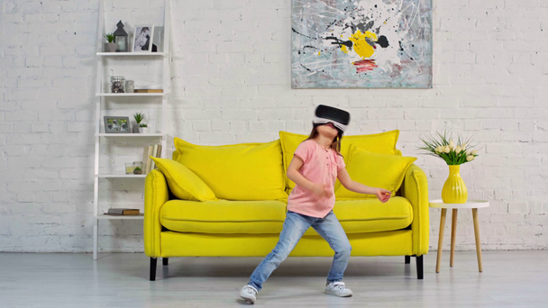 cute kid in virtual reality headset dancing at home  - Footage, Video