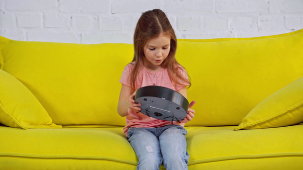 kid looking at robotic vacuum cleaner and showing thumb up - Footage, Video