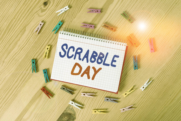 Handwriting text writing Scrabble Day. Concept meaning a day to celebrate the popular board game created in 1938 Colored clothespin papers empty reminder wooden floor background office. - Photo, Image