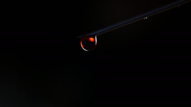 Shooting of syringe needle with drop of blood on the black background. - Footage, Video