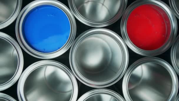 Open cans of paint on a black background. red and blue - Footage, Video