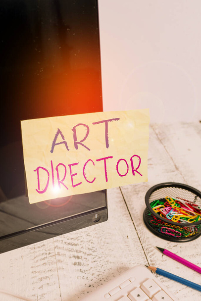 Text sign showing Art Director. Conceptual photo responsible for overseeing the artistic aspects of a film Note paper taped to black computer screen near keyboard and stationary. - Photo, Image
