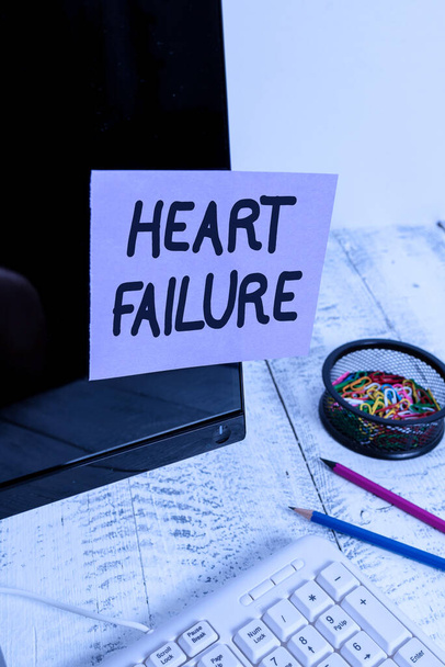 Handwriting text Heart Failure. Concept meaning the severe failure of the heart to function properly Note paper taped to black computer screen near keyboard and stationary. - Photo, Image