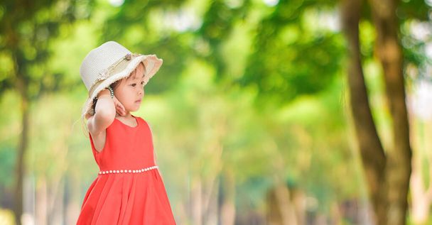 Roztomilá holčička v zeleném parku za slunečného dne - Fotografie, Obrázek