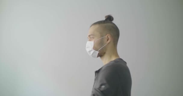 Young Caucasian Man with Blond Hair  is Singing and Dancing Using a Disposable Face Mask for Covid-19, Cough, Flu, Virus, Viral Protection.  - Imágenes, Vídeo