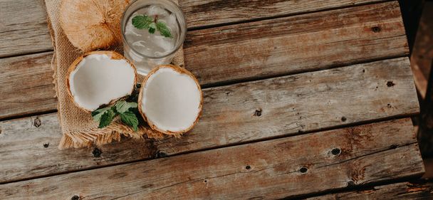 Coconut water. Fresh and delicious coconut water. wood and green background. - 写真・画像