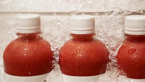 Close Up of Fresh Squeezed Strawberry Juice in Plastic Bottles - Felvétel, videó