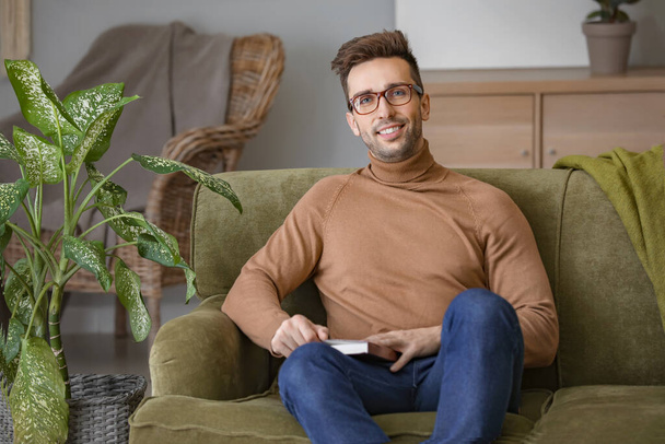Young man with stylish eyeglasses at home - Photo, Image