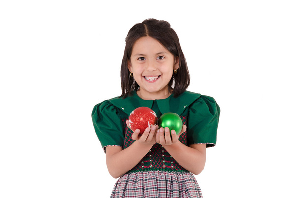 Adorable girl wearing a green Christmas holiday dress with ornaments - Фото, зображення
