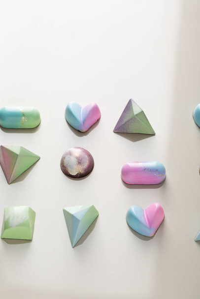 Overhead view of pastel colour chocolate candies - Photo, image