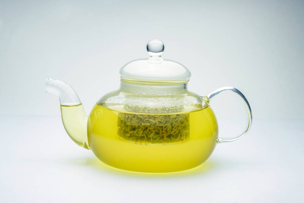 fennel seeds loose inside glass teapot brewed for healthy drink on white background - Fotoğraf, Görsel