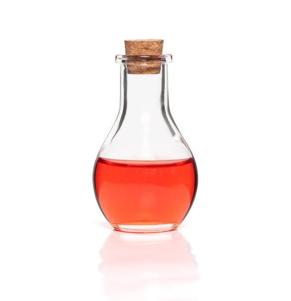 red liquid in a glass bottle. Isolated on white with clipping path - Foto, Bild