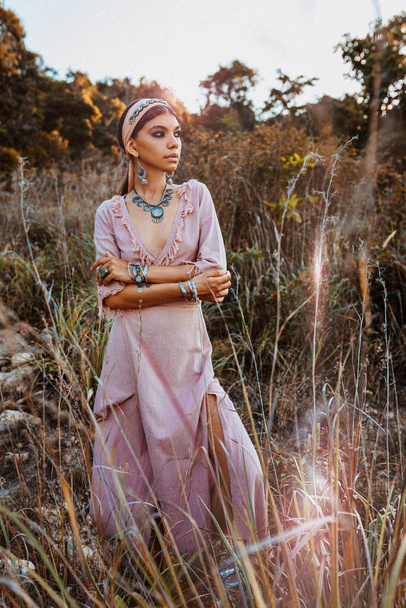 beautiful young fashionable woman in dress on the field at sunset - Foto, afbeelding